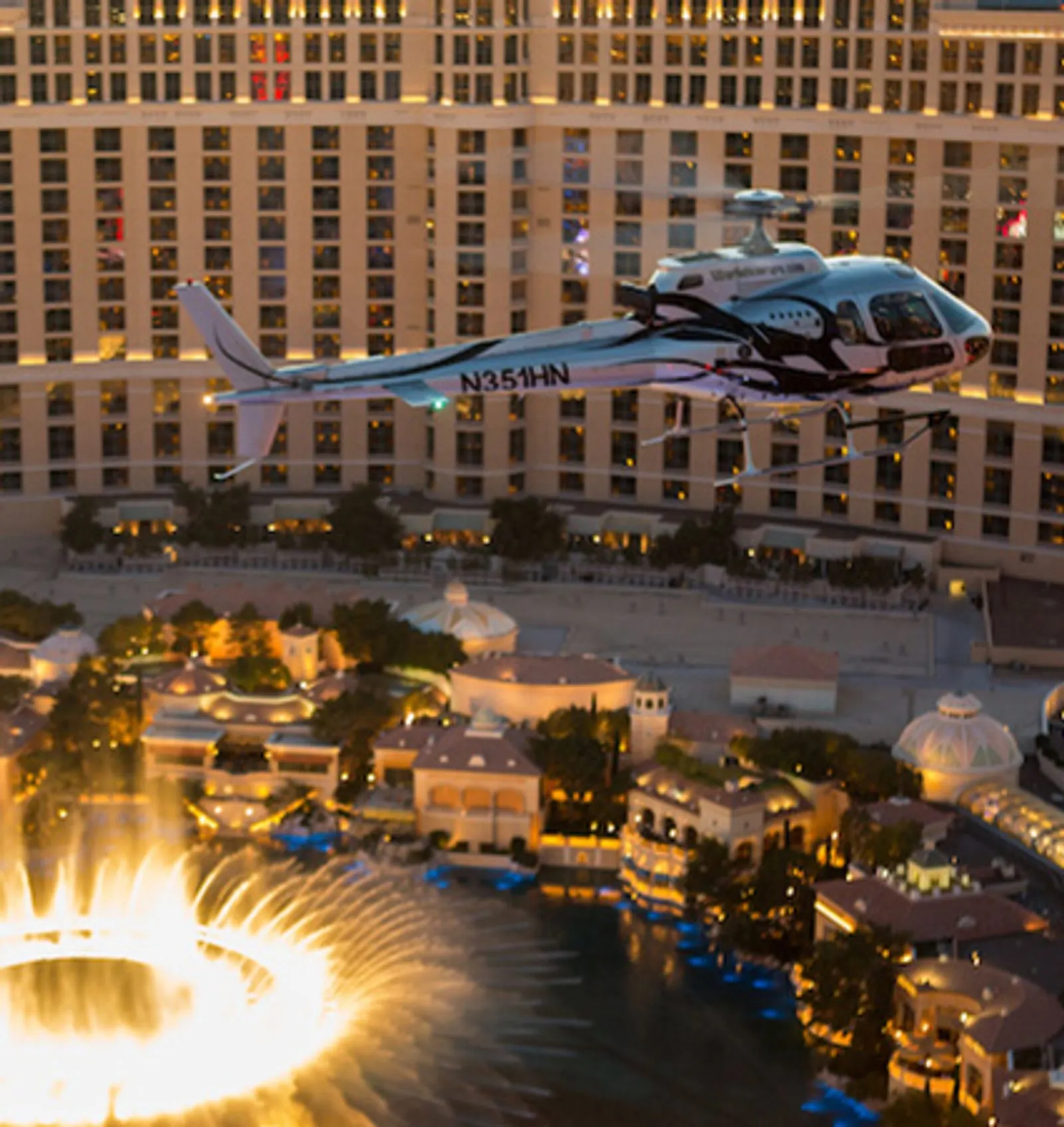 Bellagio fountains lit up at night seen from a helicopter