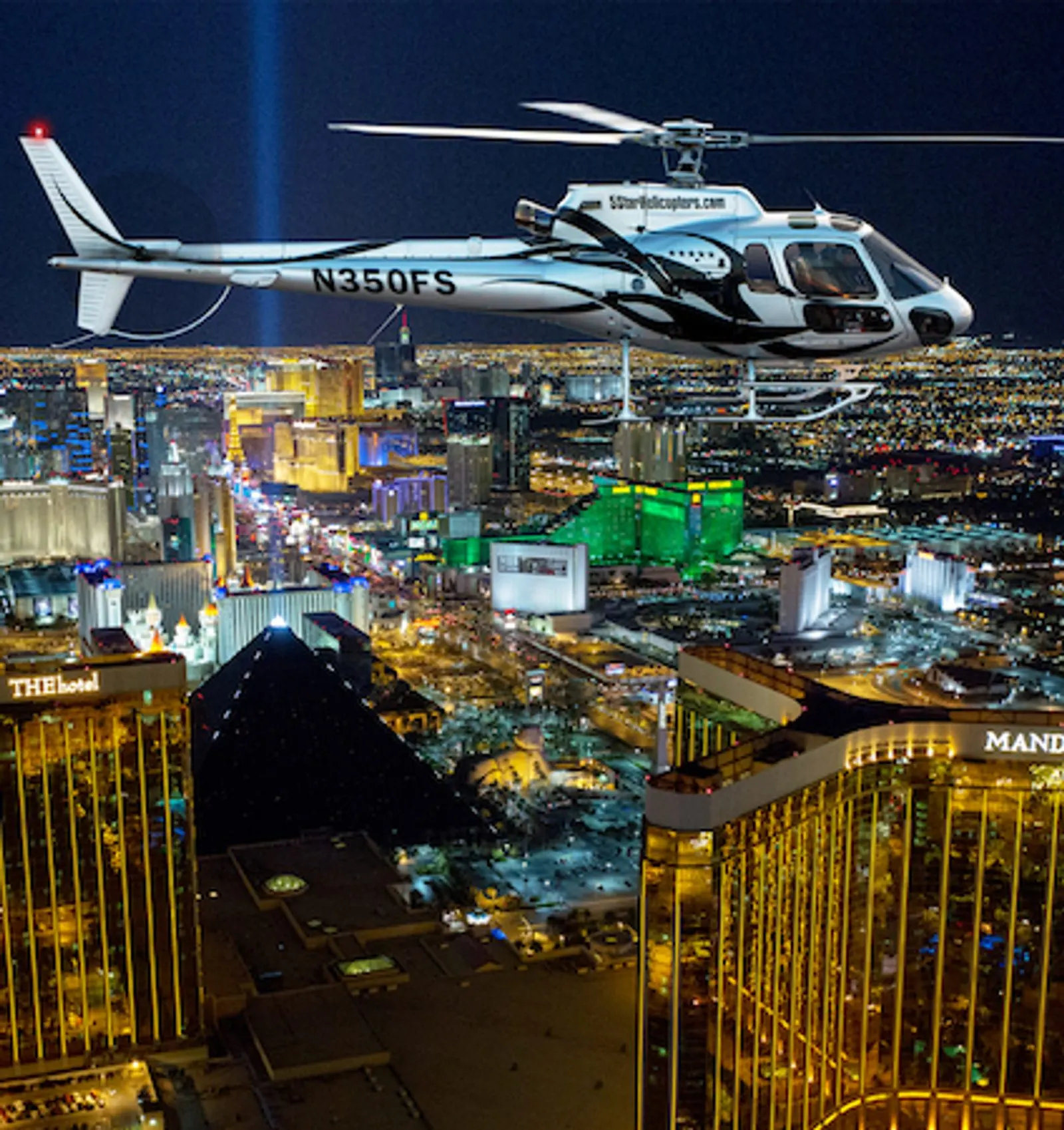 Helicopter banking over the Las Vegas Strip lights at night